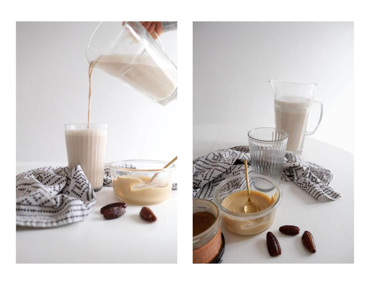 Cremige Haselnussmilch wird frisch aus einer Glaskaraffe in ein Glas gegossen